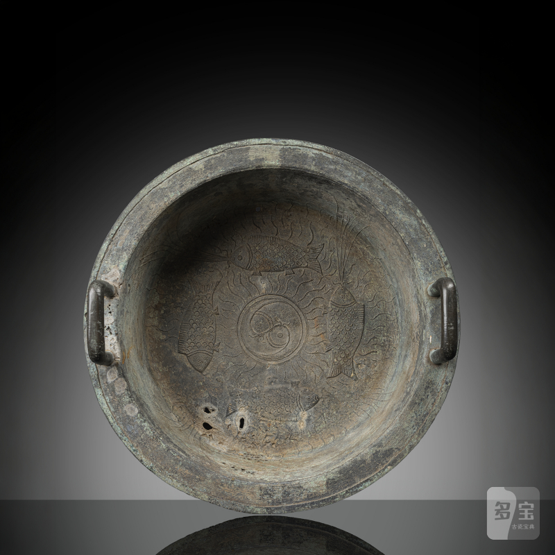 A bronze basin with relief and engraved decoration of fishes around a 'yin yang' symbol